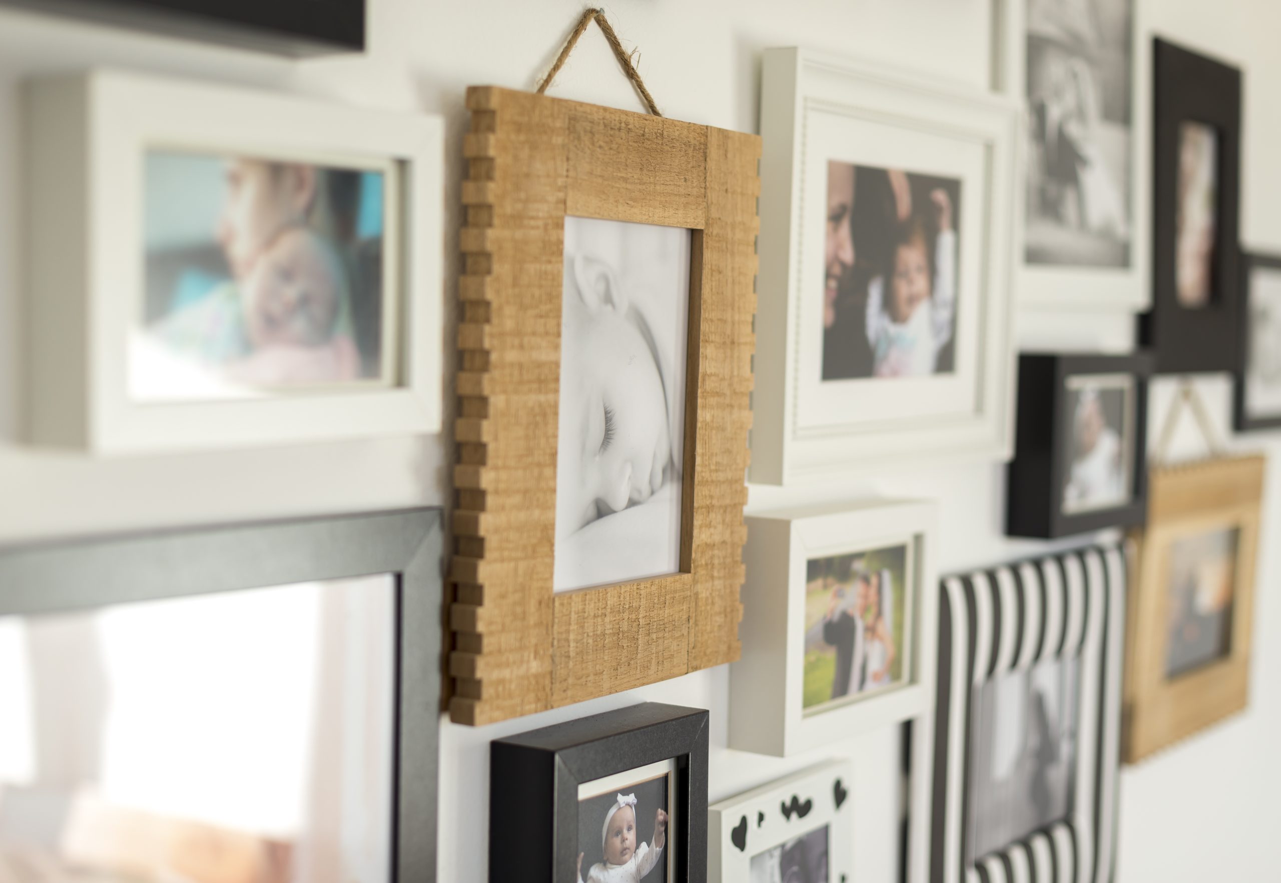 photos of baby in frames on wall